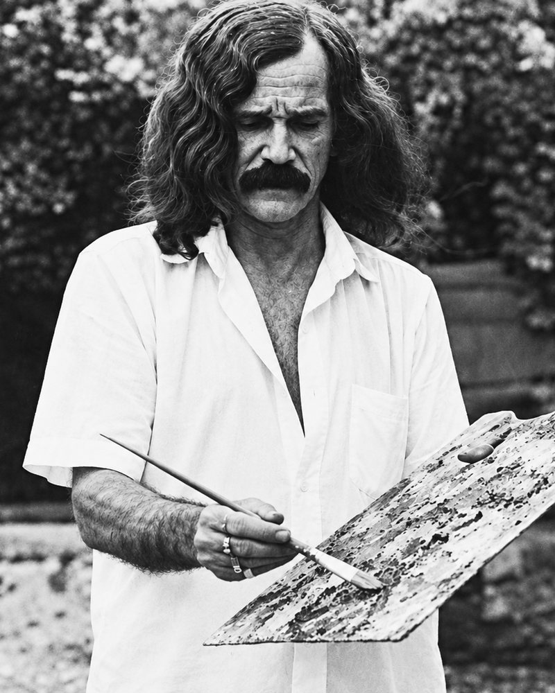 Black-and-white photograph of Mario Rodríguez, the artist's grandfather, painting outdoors