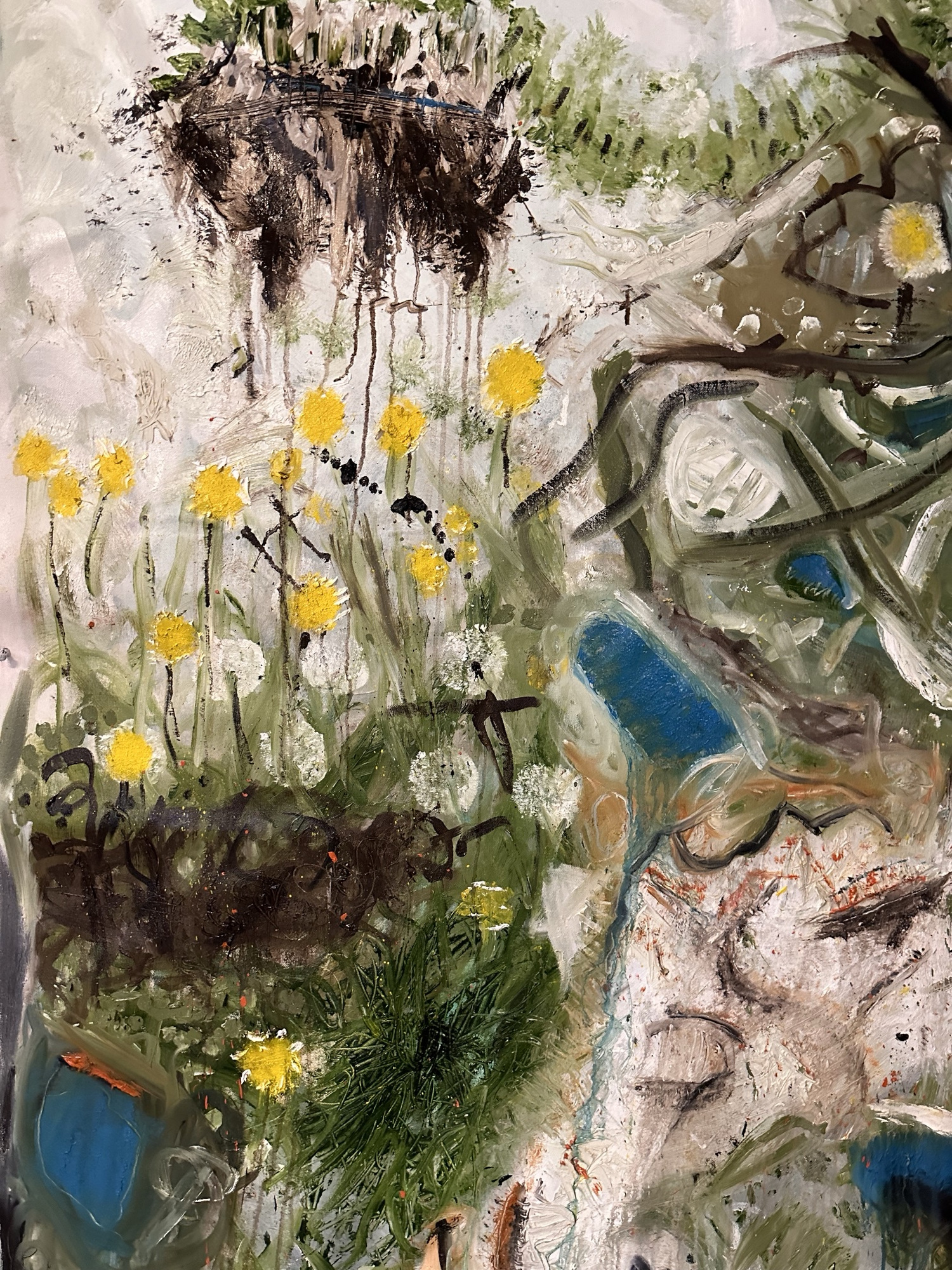 Detail: yellow dandelions and white seed heads in green grass beneath a floating clod of dark earth with dripping paint, beside a pale passage with blue strokes