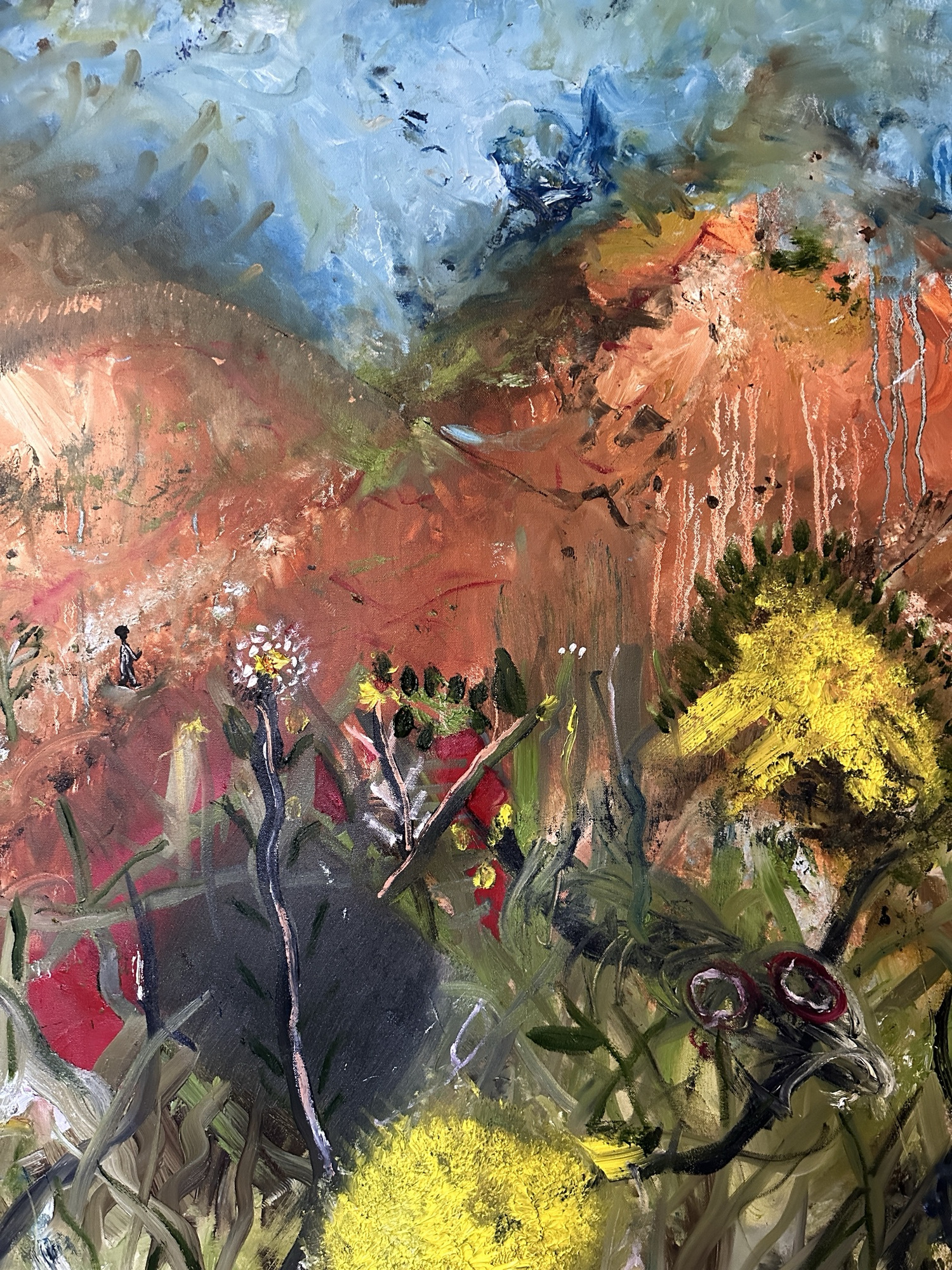 Detail: a tiny walking figure on a terracotta hill, a white dandelion-like flower, yellow blooms and a dark shadow