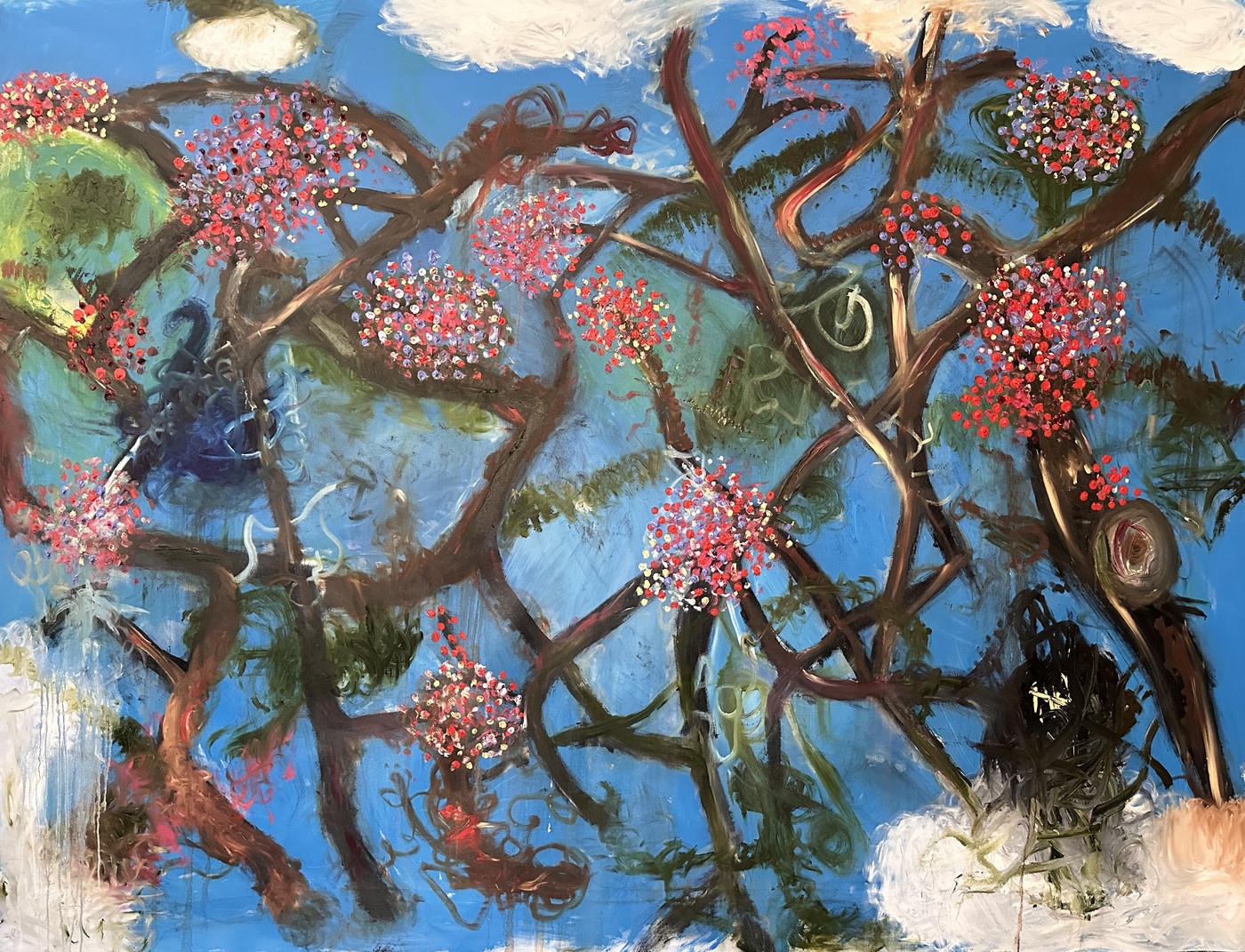 Abstract painting: clusters of red, lilac and yellow blossoms on tangled brown branches against a bright blue sky, with white cloud forms at the edges