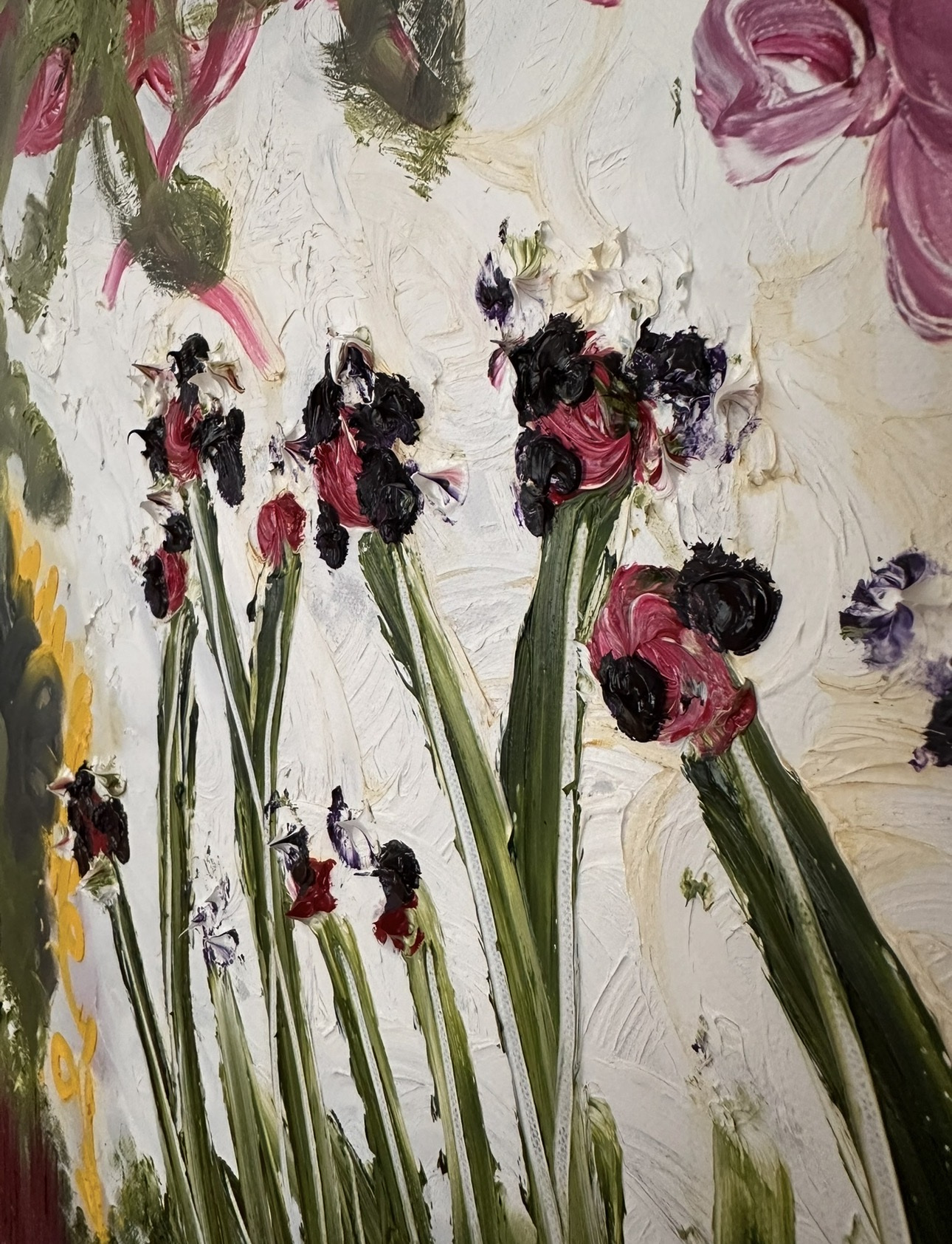 Detail: thick impasto blooms in black and crimson on tall green stems against cream paint